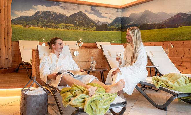 Ein Paar entspannt im Ruheraum der Wellnesslandschaft